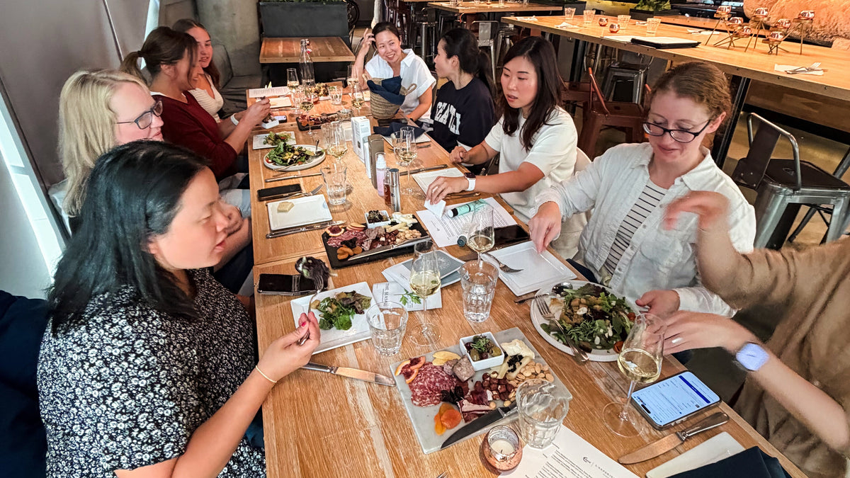 Women gathered at a ViaJiin Night, trying Korean skincare products together over drinks and snacks